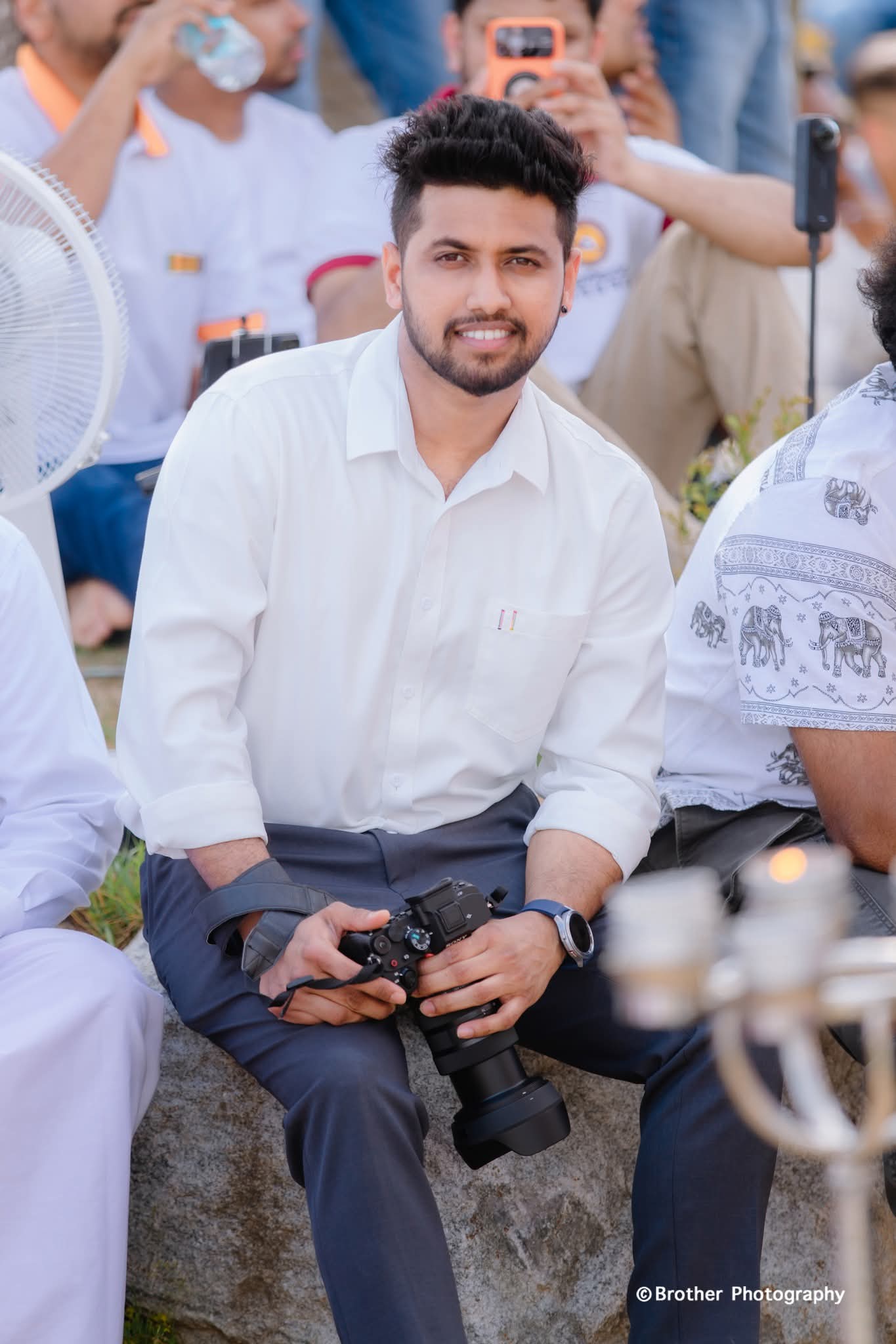Lalith Gamage holding a camera